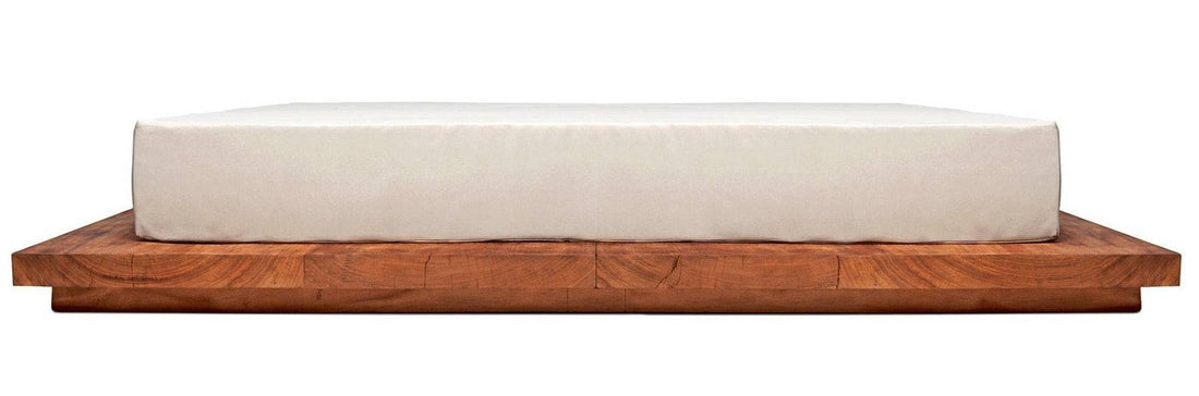 A luxurious Double Daybed Suar with a cushion on it, made from suar wood, designed for relaxation outdoors.