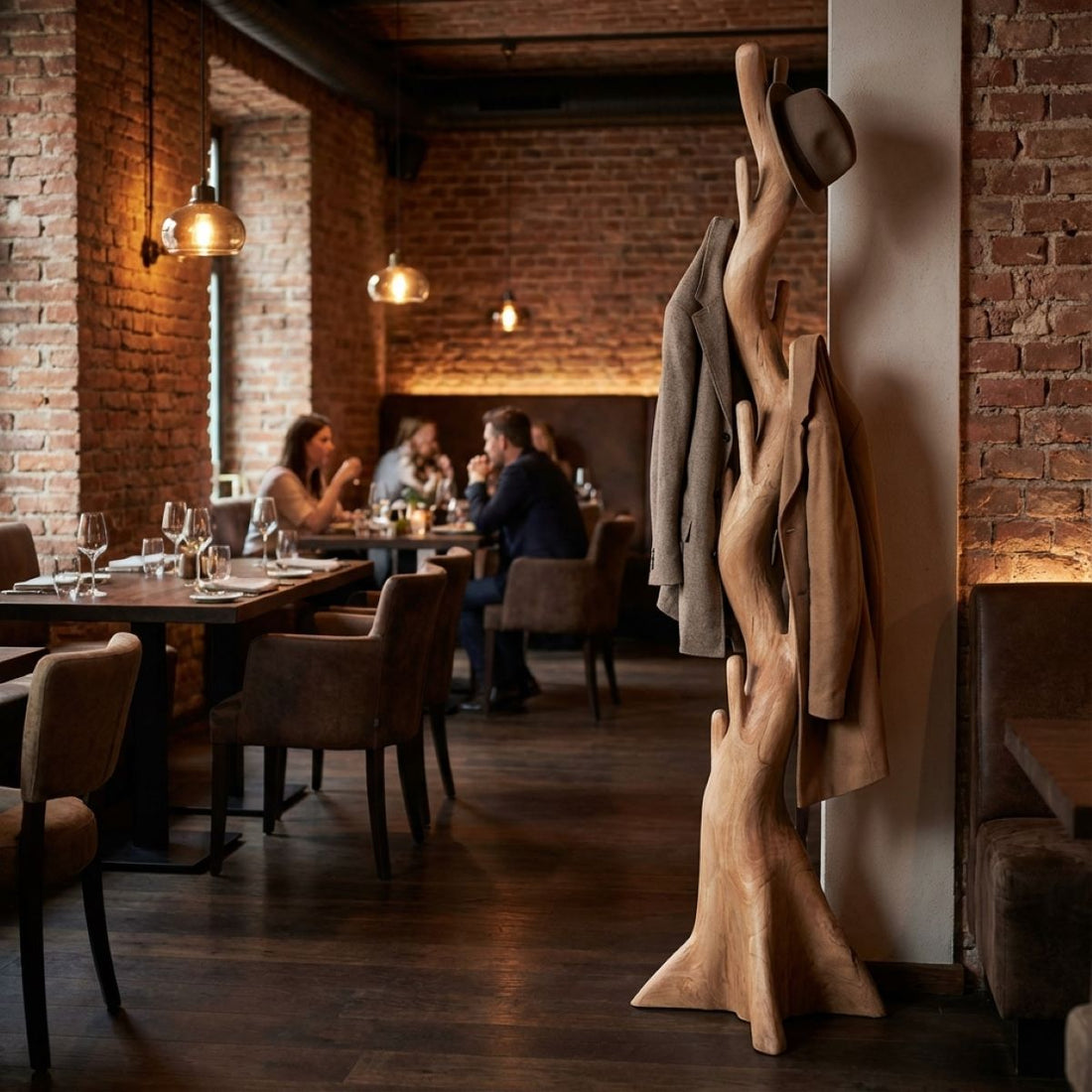 Dining area with brick walls, wooden floor, and people seated at tables.