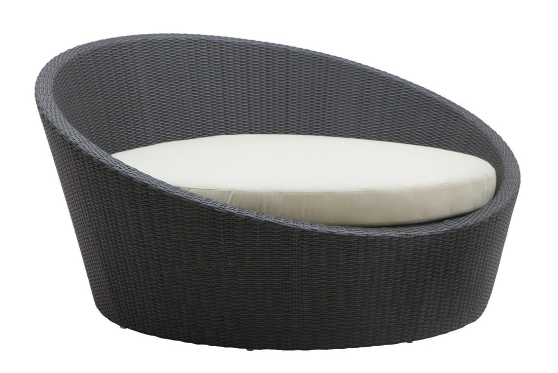 A luxurious outdoor daybed with a minimalistic design, featuring a dark-colored frame and a white cushion.
