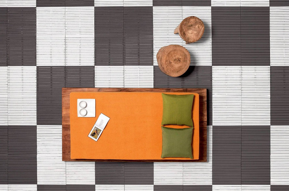 Suar wood daybed with vibrant orange cushion and accent pillows, styled top view