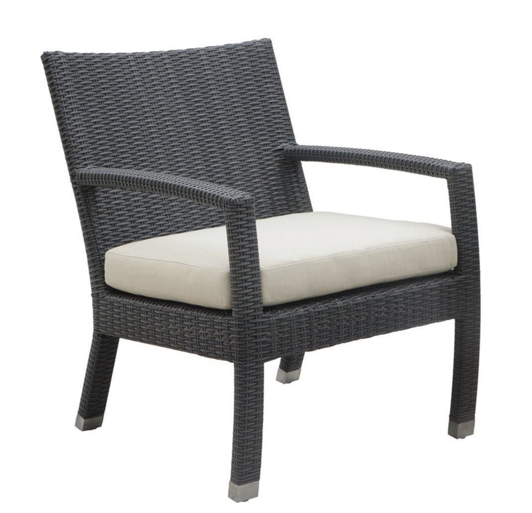 A modern silhouette lounge chair with dark brown wicker frame and beige cushion.