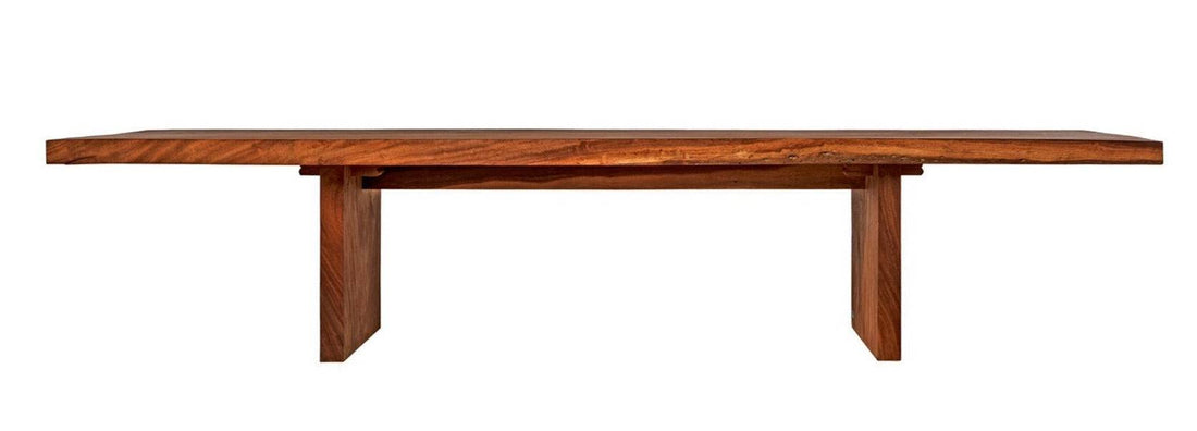A low rectangular dining table made of Suar wood with a visible wood grain