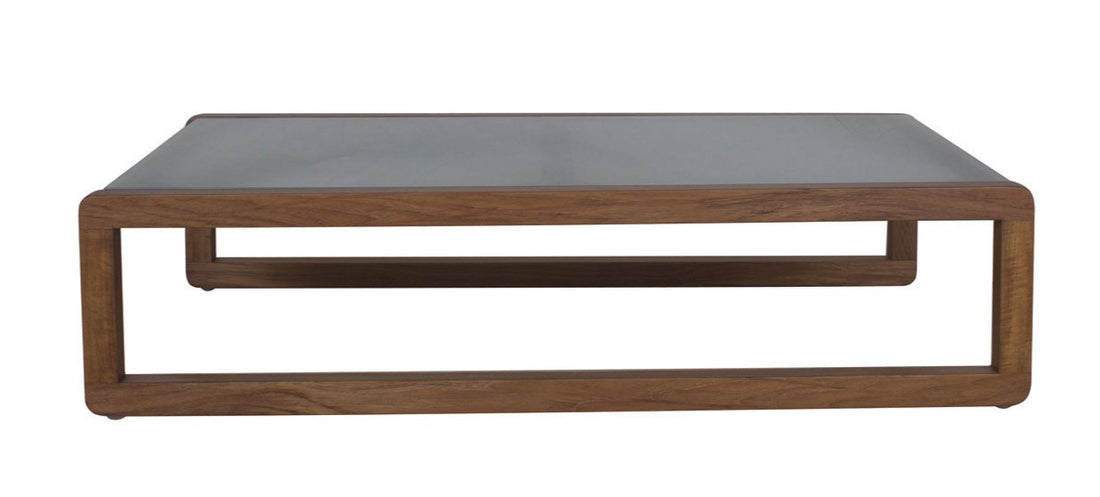 A rectangular coffee table with a frosted glass top and a brown wooden dual-frame base.