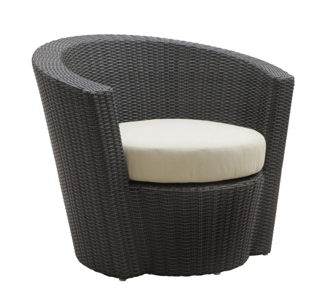 A black lounge chair with curved armrests and a white cushion 